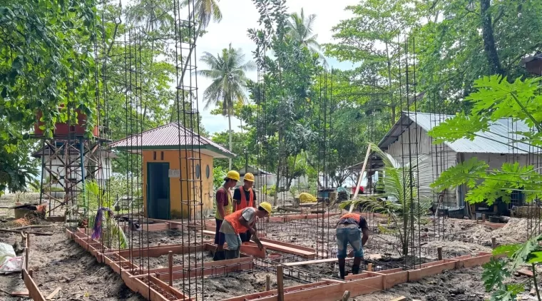 pekerja sedang mengerjakan pembangunan toilet di objek wisata Pulau Angso Duo.