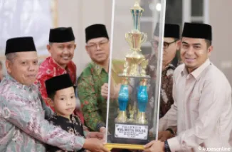 Wako Ramadhani Kirana Putra (kanan), Kabag Kesra, Feri Hendria (baju batik merah) dan Pejabat lainnya, saat penyerahan Piala kepada Pemenang MTQ.