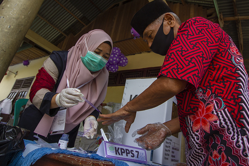 Masyarakat Indonesia menggunakan hak memilih pada pemilihan umum serentak 2020 di masa pandemi virus Covid-19 dengan mematuhi protokol kesehatan di Kelurahan Limau Manis Selatan, Kecamatan Pauh, RT2/RW2, Kota Padang, Sumatera Barat on December 9, 2020. | 