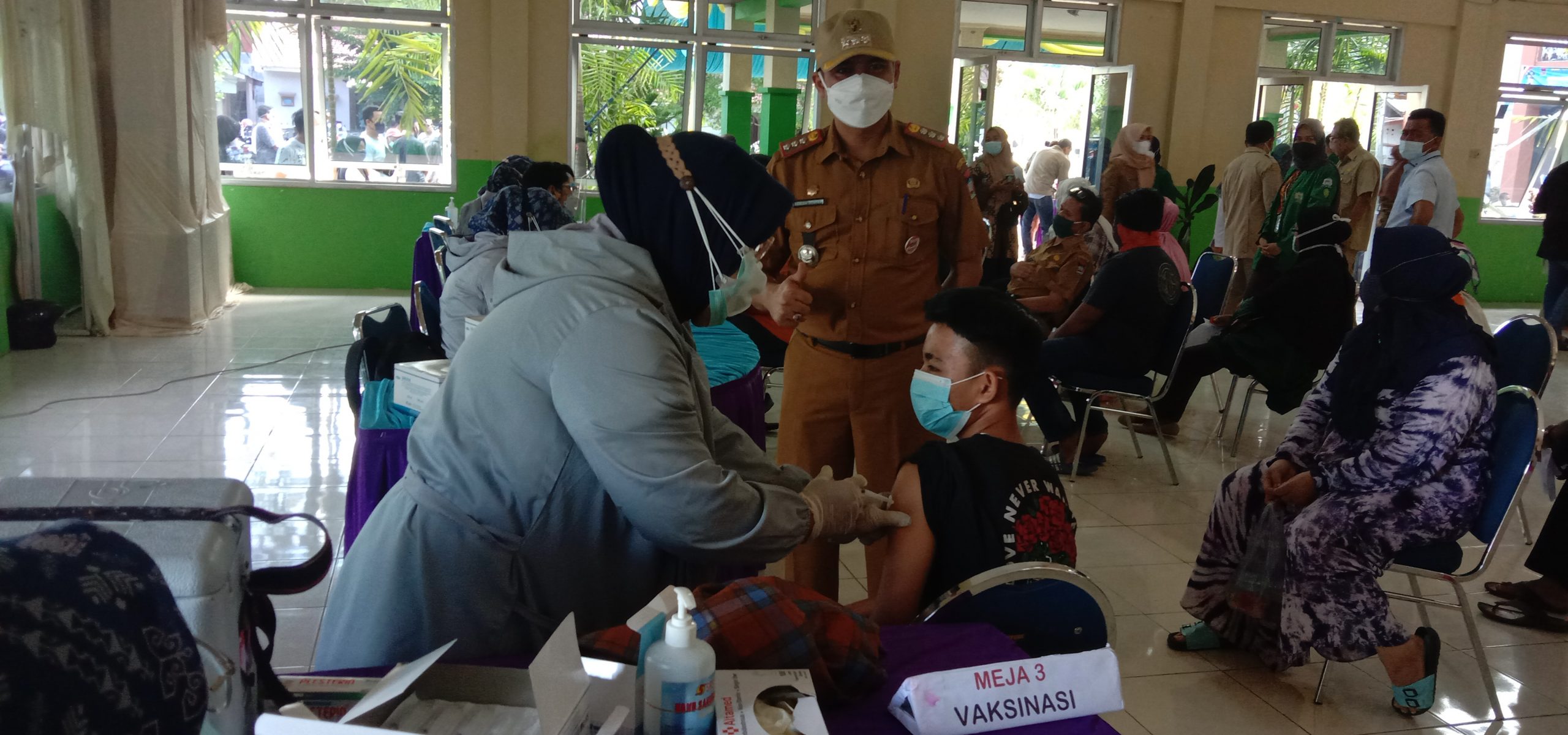 Camat Lubuk Begalung, Heriza Syafani mendampingi peserta vaksin termuda di hari pertama gebyar vaksinasi Covid-19 di Kecamatan Lubuk Begalung, Selasa (2/8/2021) pagi. (Foto: Dok. Istimewa)