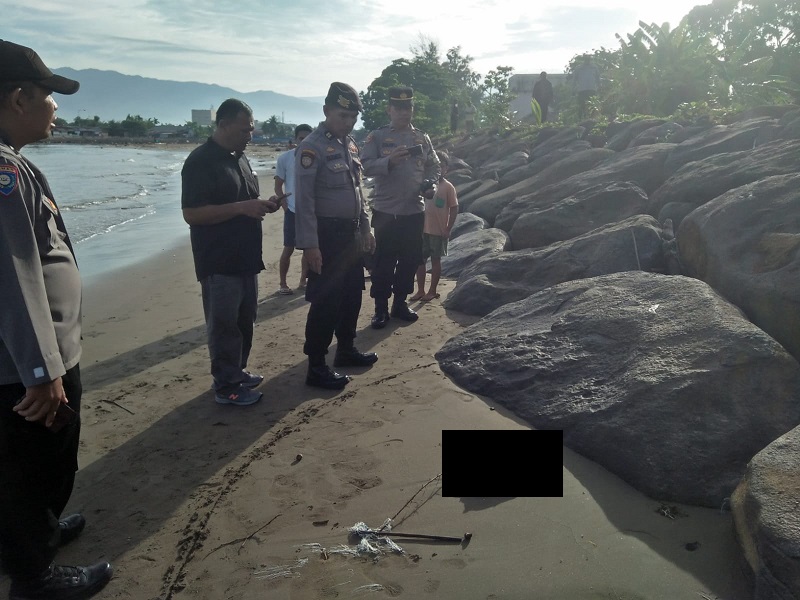 Petugas melihat jenazah bayi yang ditemukan oleh nelayan di Padang